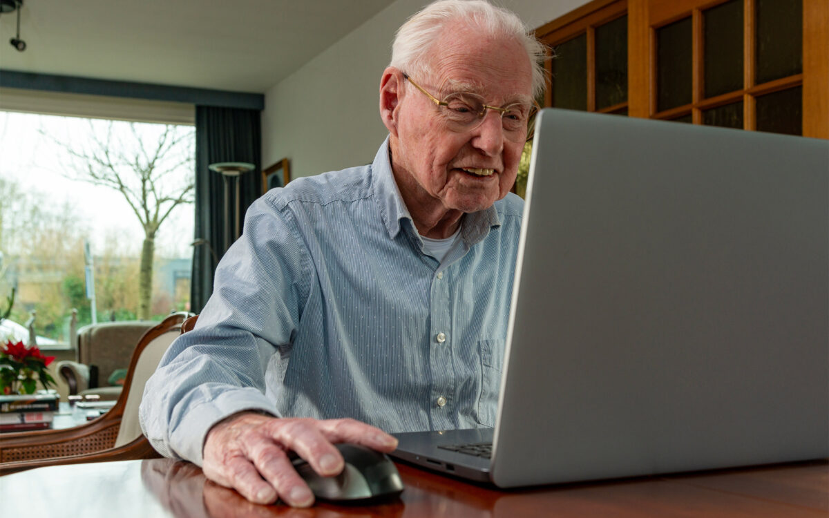 Elderly man with computer.